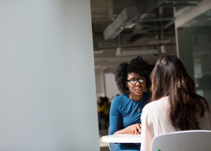 Woman Wearing Blue Top Beside Table